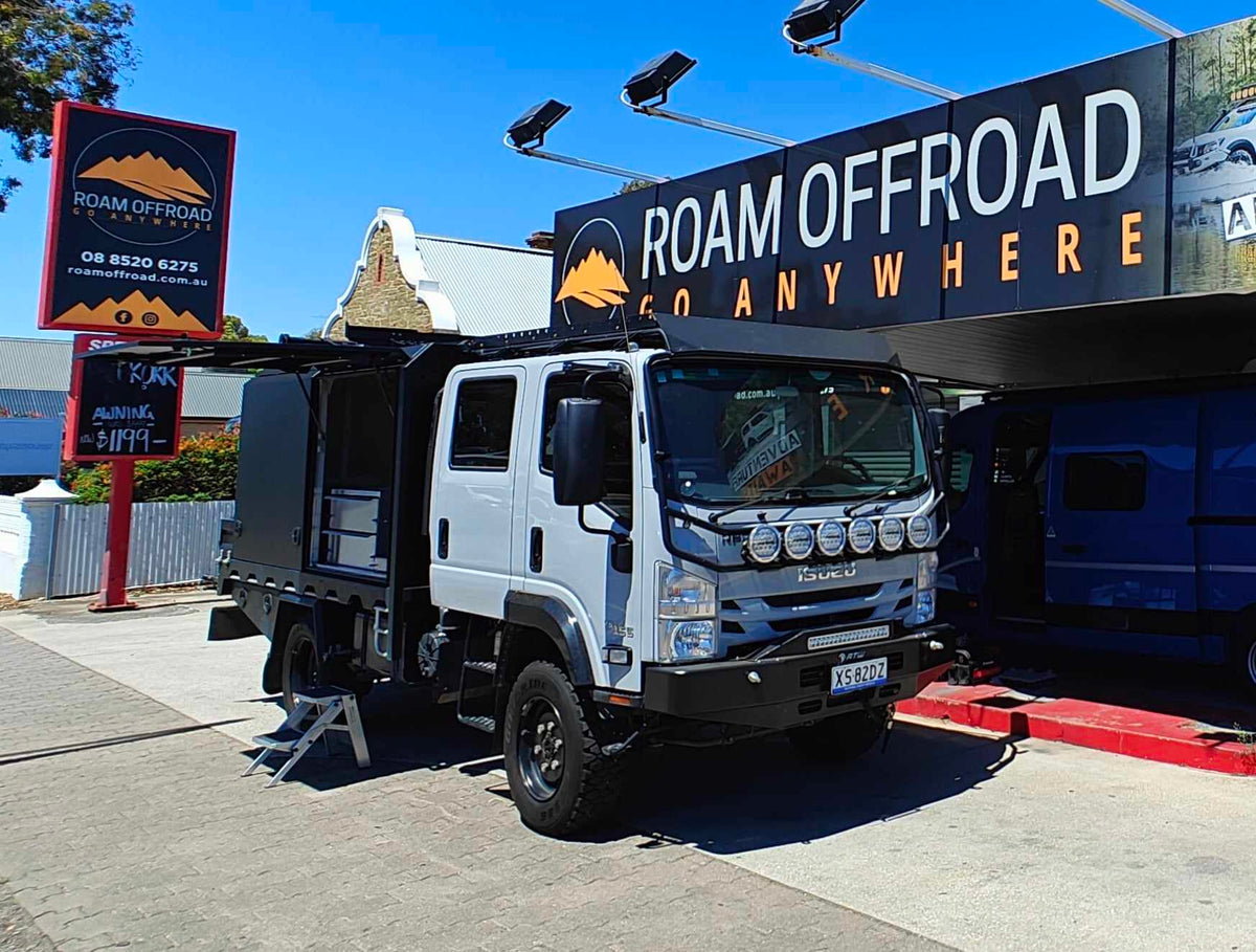 Isuzu 4x4 truck with aluminium canopy and roof lights outside Roam Offroad in Gawler South
