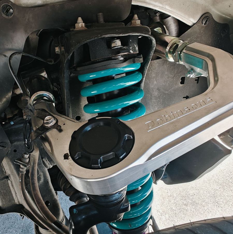 Dobinsons upper control arm with a teal coilover