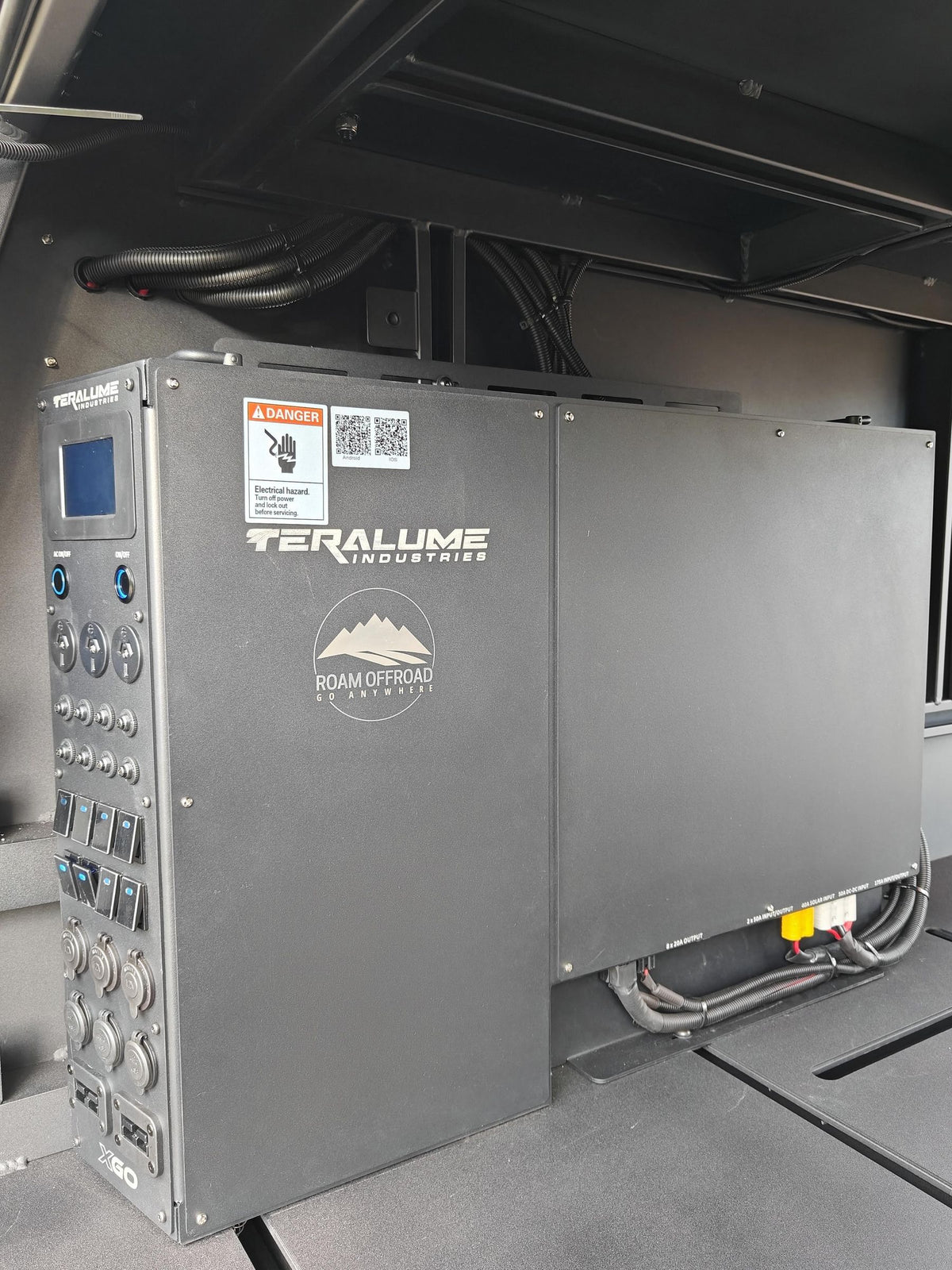 Teralume power tower with a screen, switches, outlets and the Roam Offroad logo, inside a canopy