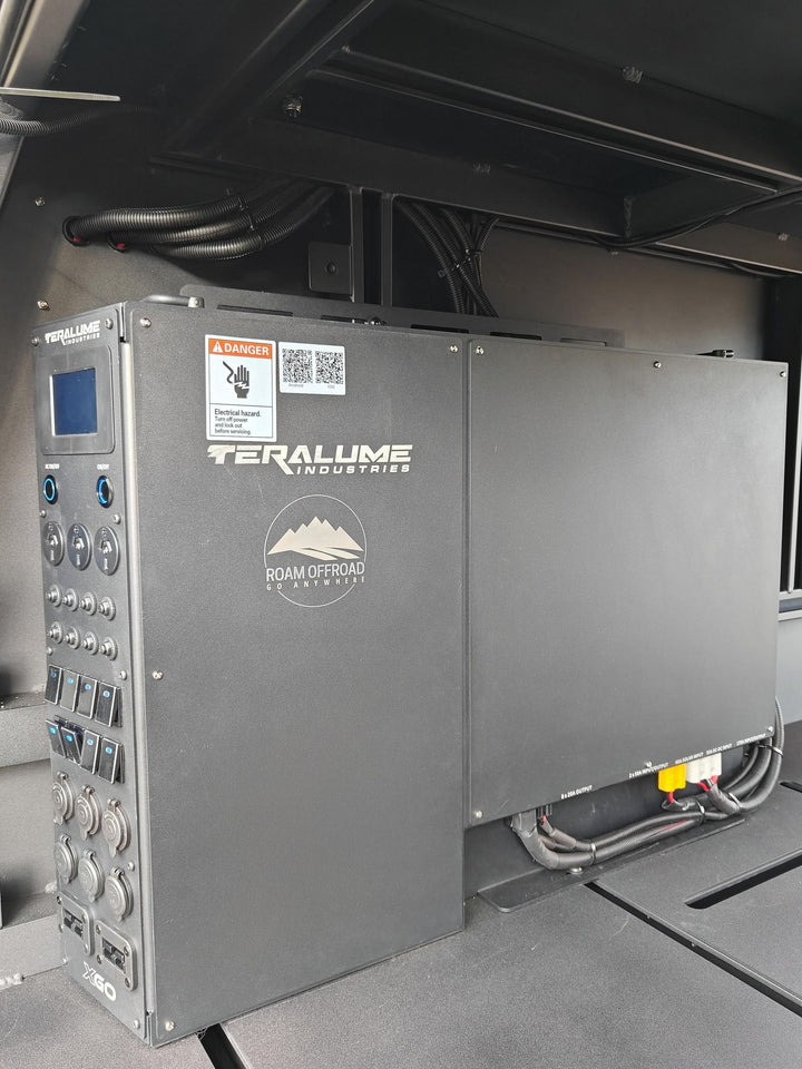 Teralume power tower with a screen, switches, outlets and the Roam Offroad logo, inside a canopy