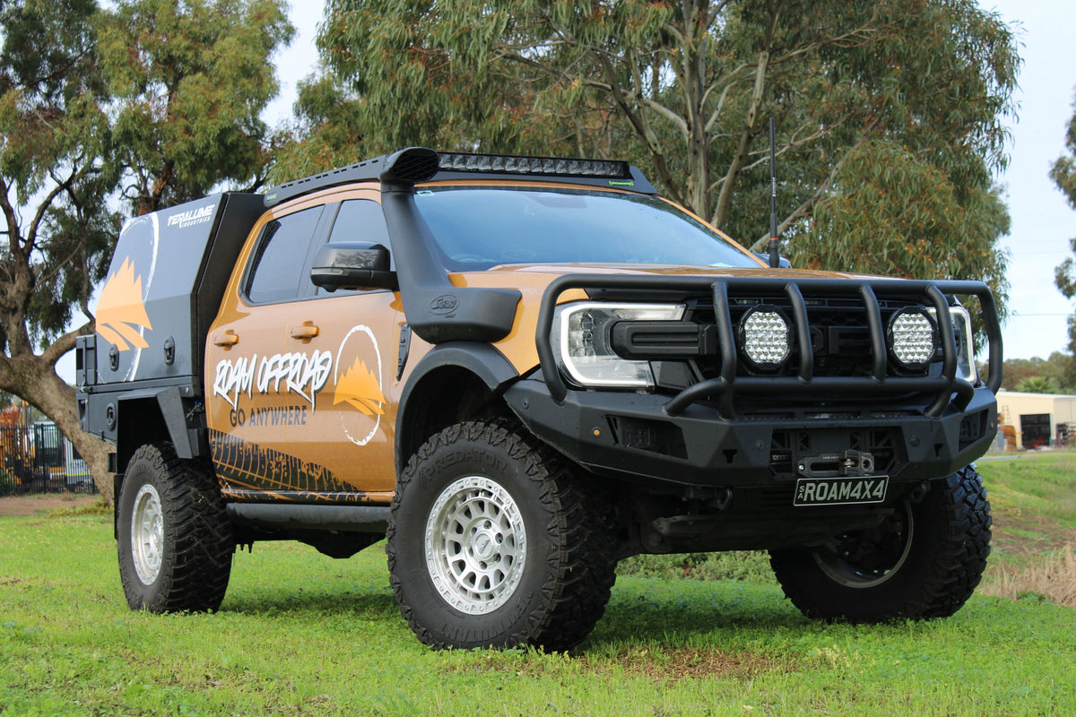 Roam Offroad Ford Ranger with a tray, canopy, bull bar, driving lights and snorkel, parked on grass