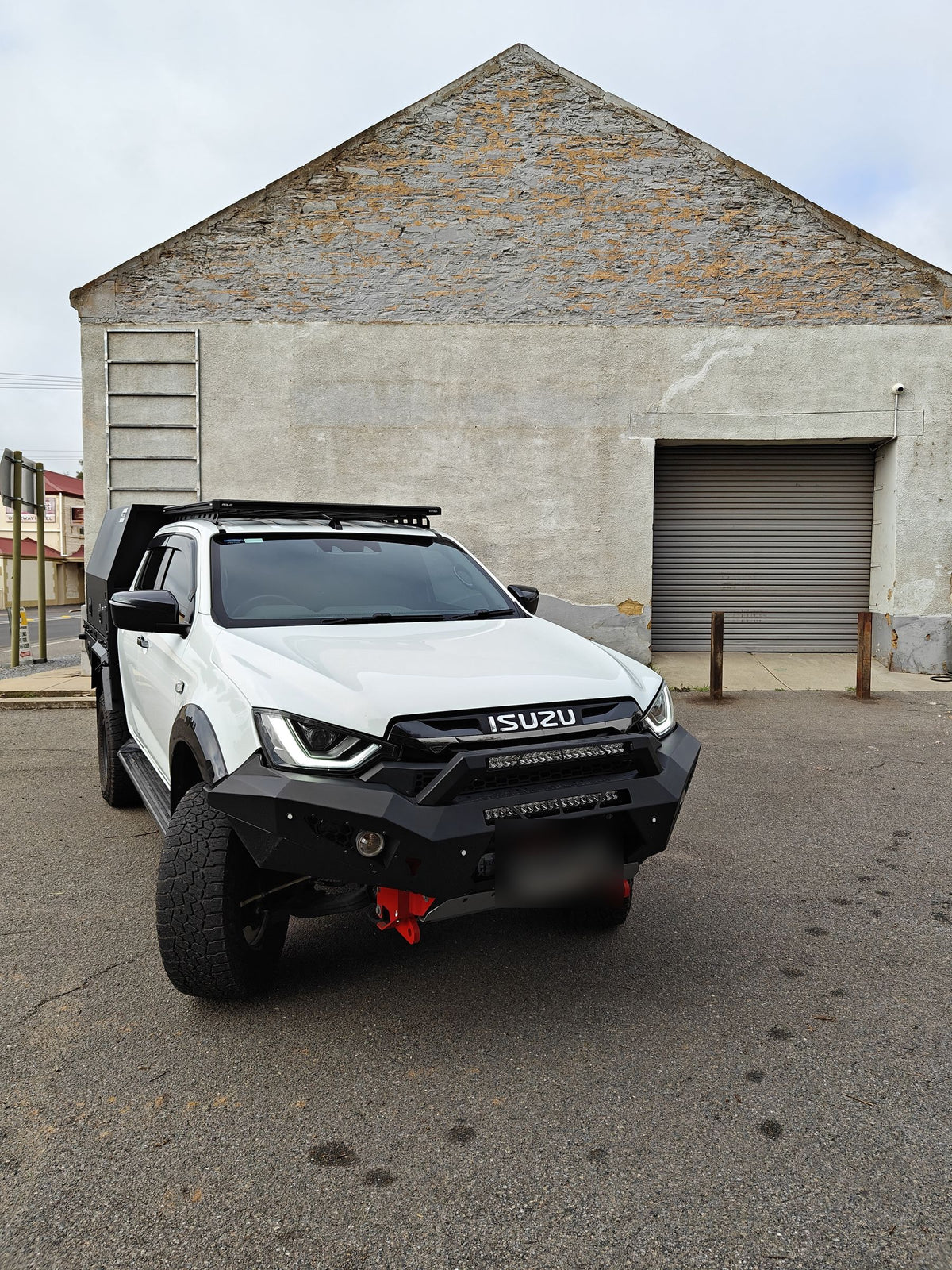 Front of the Isuzu D-Max showing the bull bar, light bar and red recovery points