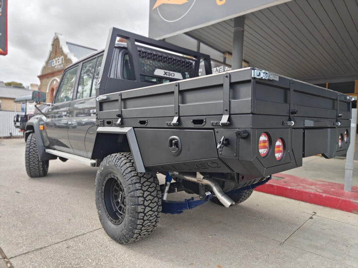 Rear three-quarter view of the XGO tray with side toolboxes and tail lights