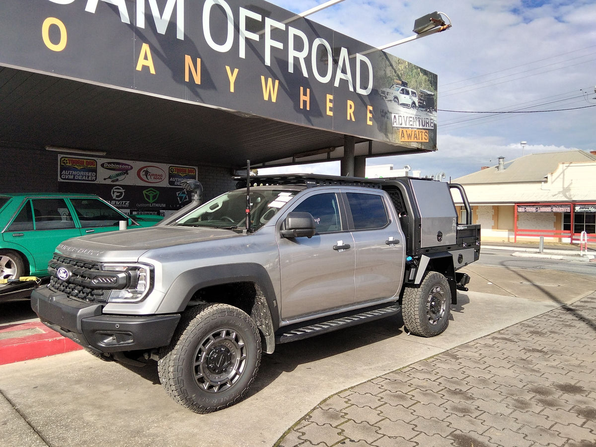 Silver Ford Ranger with a two-tone tray and canopy outside the Roam Offroad shop