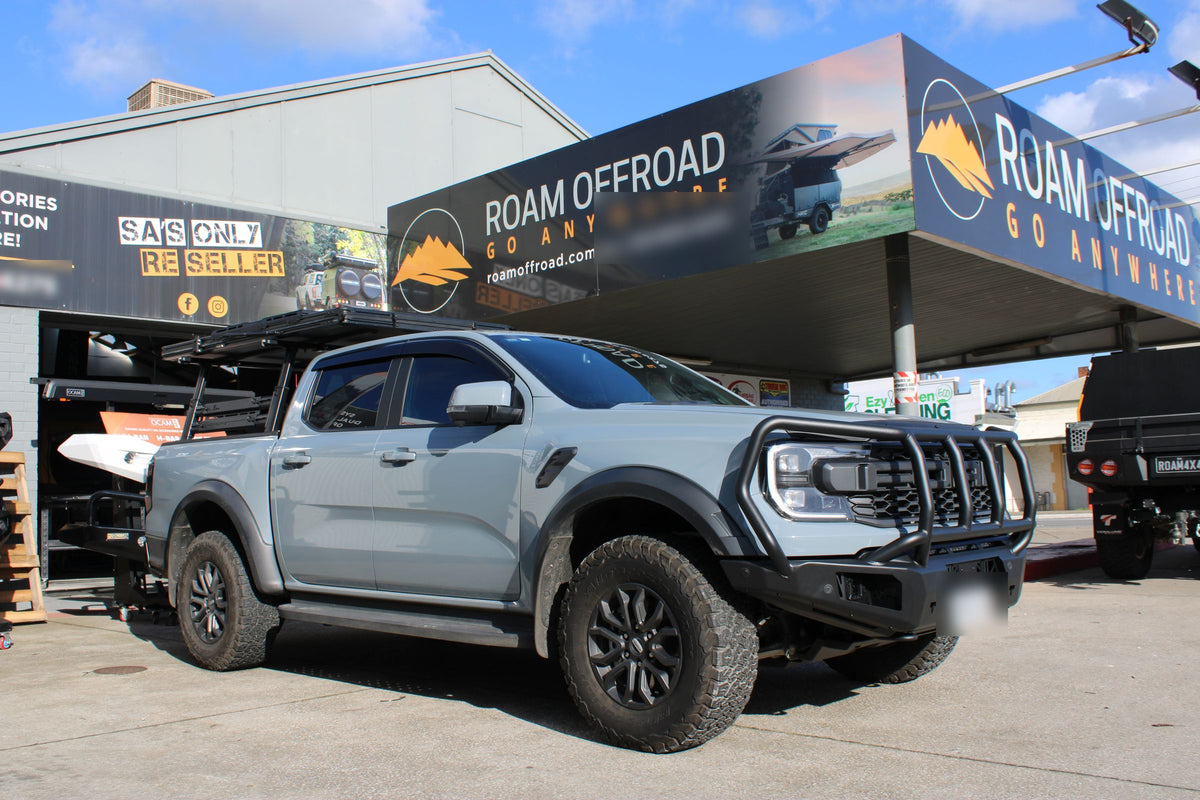 Grey Ford Ranger Raptor with a Vikor bull bar under the Roam Offroad sign