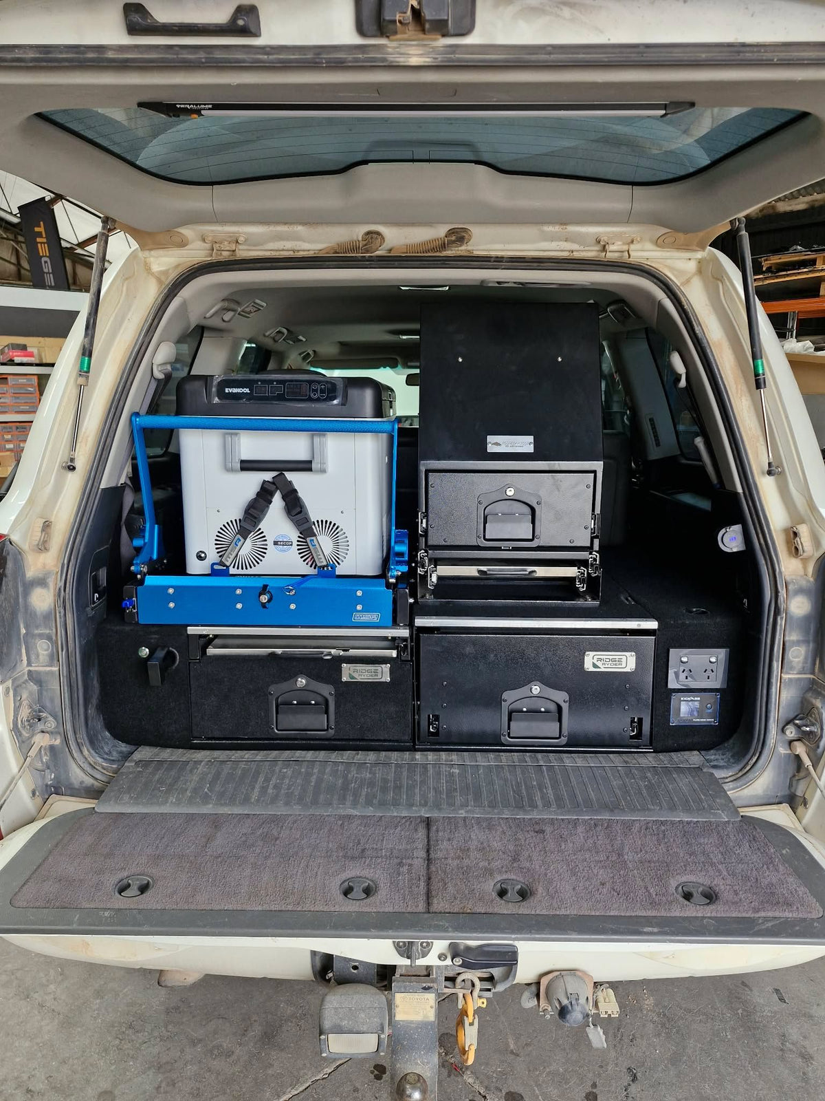 Wagon cargo area fitted with twin drawers, a fridge on a slide and a drawer module